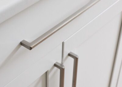 Brushed Cabinet Hardware on White Cabinets