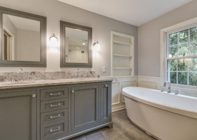 double sink vanity next to freestanding bath tub