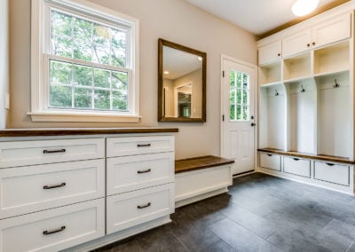 custom mudroom with slate tile and built in storage