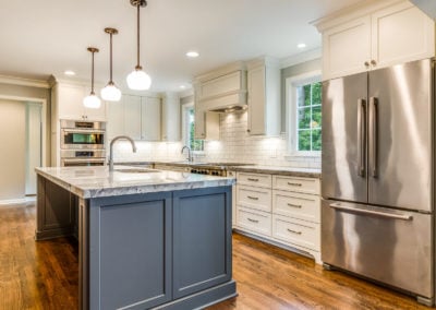 two toned gray and white kitchen with stainless steel french door refrigerator