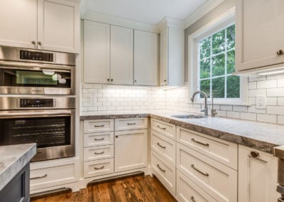 white kitchen cabinets with subway tile backsplash