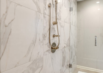 master bathroom shower with marble tile