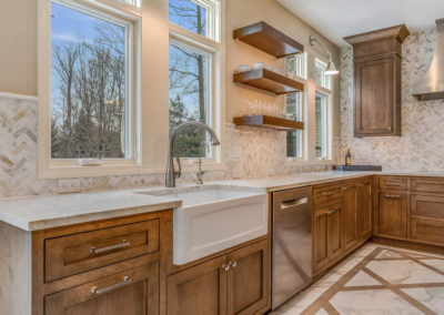 remodeled kitchen with wood cabinetry and floating shelves