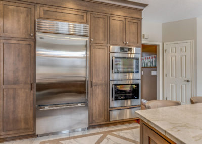 built in cabinets surrounding stainless steel fridge and double oven