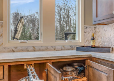 cabinets open to show pull out pot rack and lazy susan