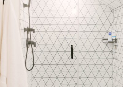 Geometric White Tiled Shower Dark Grout