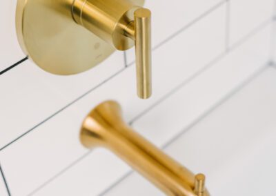 Tub Faucet Gold Accent on White Tiles