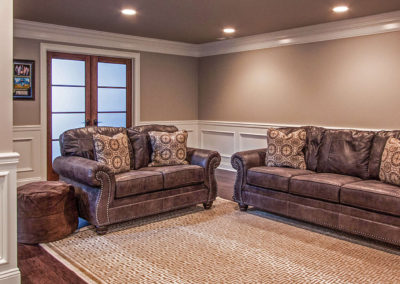 leather sofa and love seat in basement living area