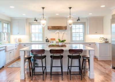 white kitchen with island and hardwood floors
