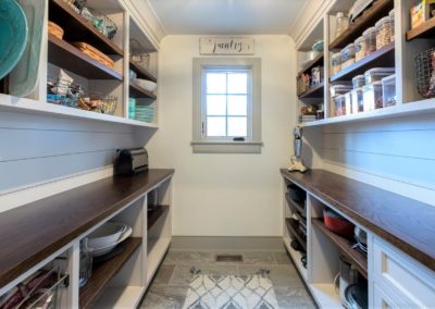 farmhouse pantry with built in shelving and wood countertops