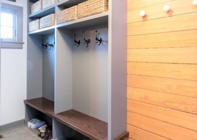 mudroom with built in benches and hooks
