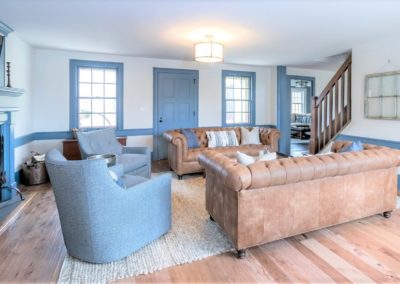sofas and arm chairs on area rug in farmhouse living room