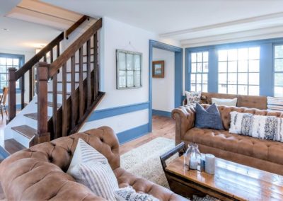 farmhouse living room with wood staircase