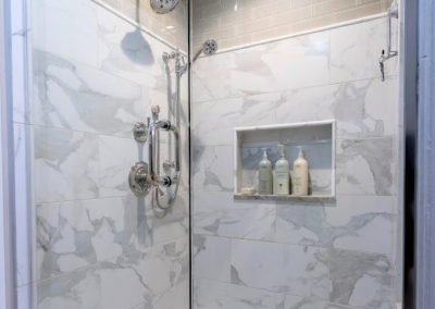 mixed gray tile shower with glass door