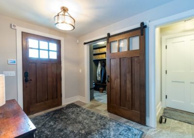 farmhouse foyer with craftsman wood doors