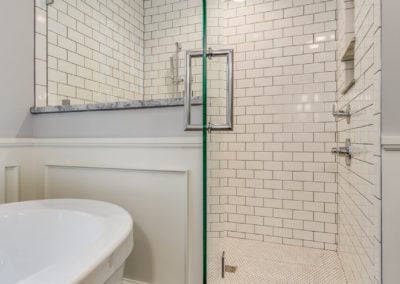 walk in tile shower with open glass door