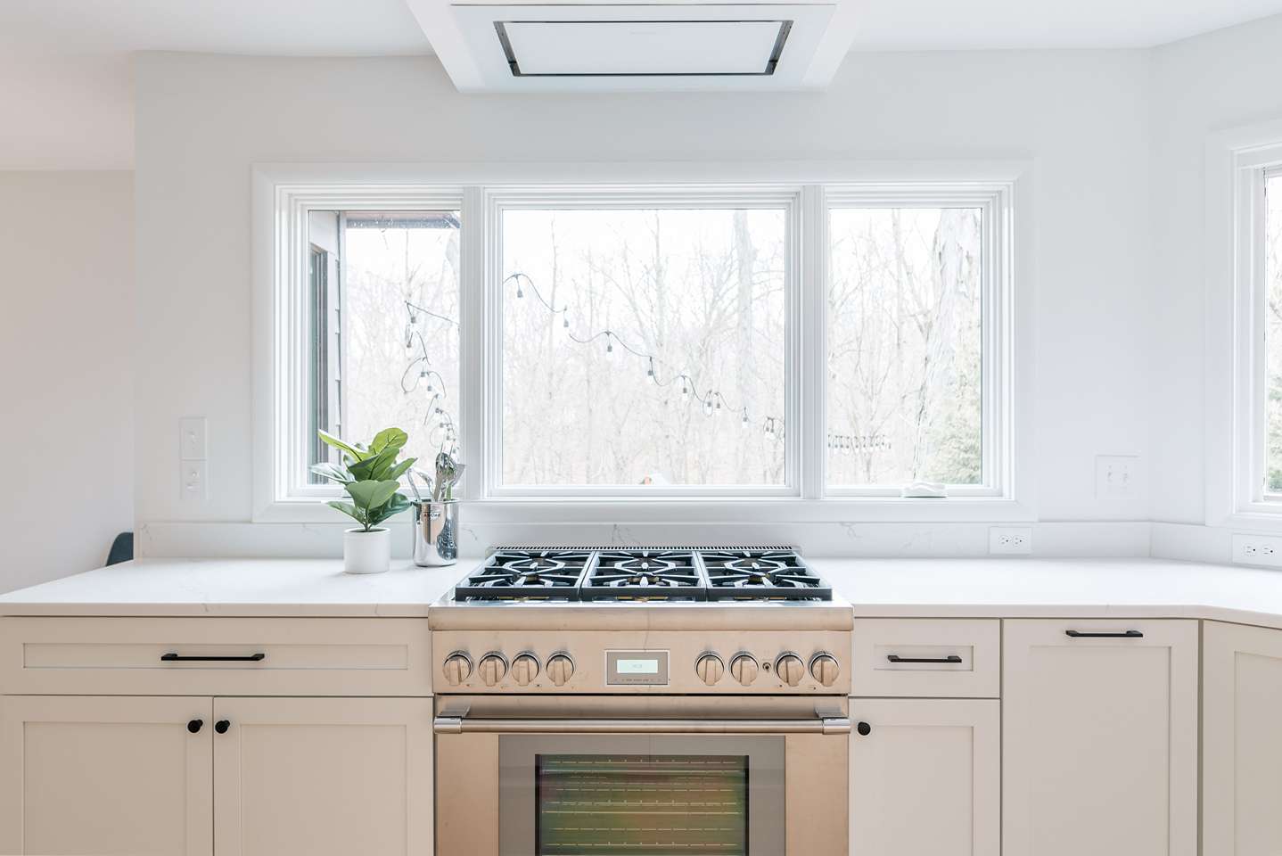 Mid Mod Cabinets and Stove Under Window Kitchen Renovation