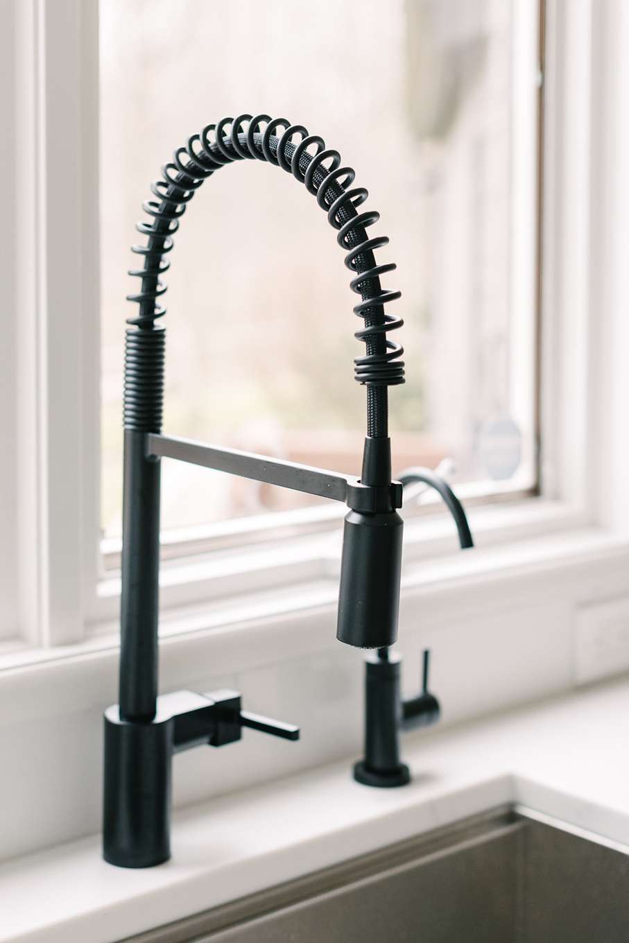 black coiled kitchen faucet