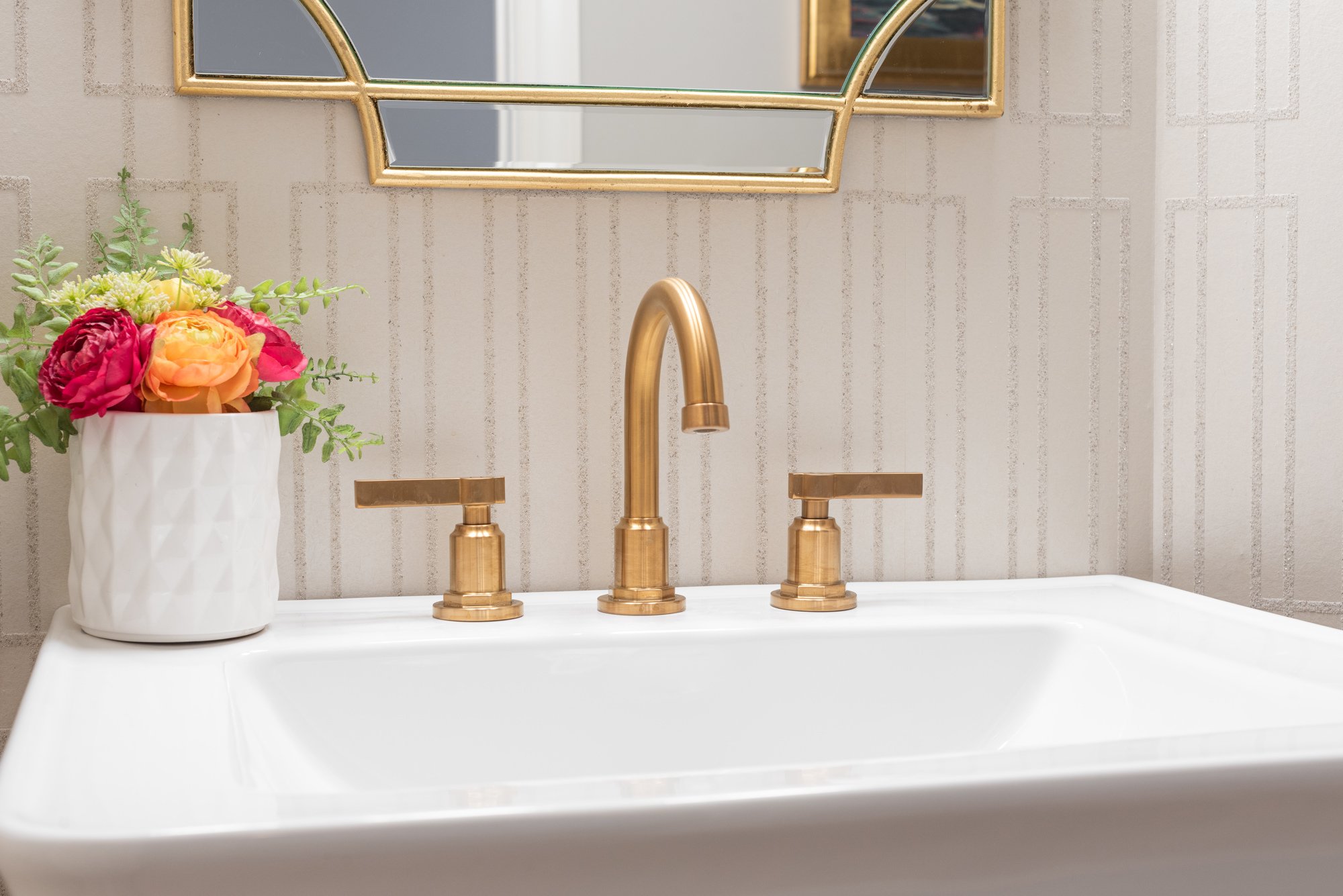 powder bathroom sink with gold faucet