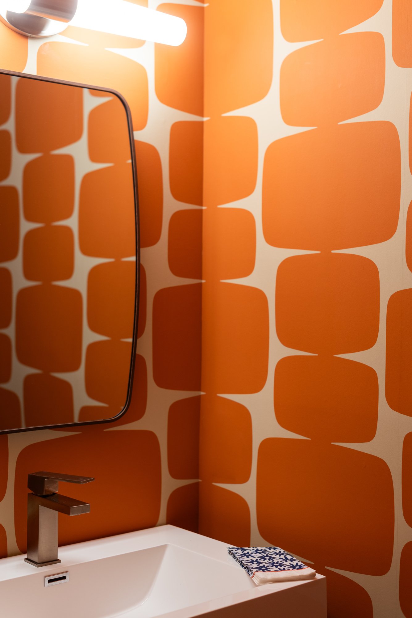 orange wallpaper in powder room