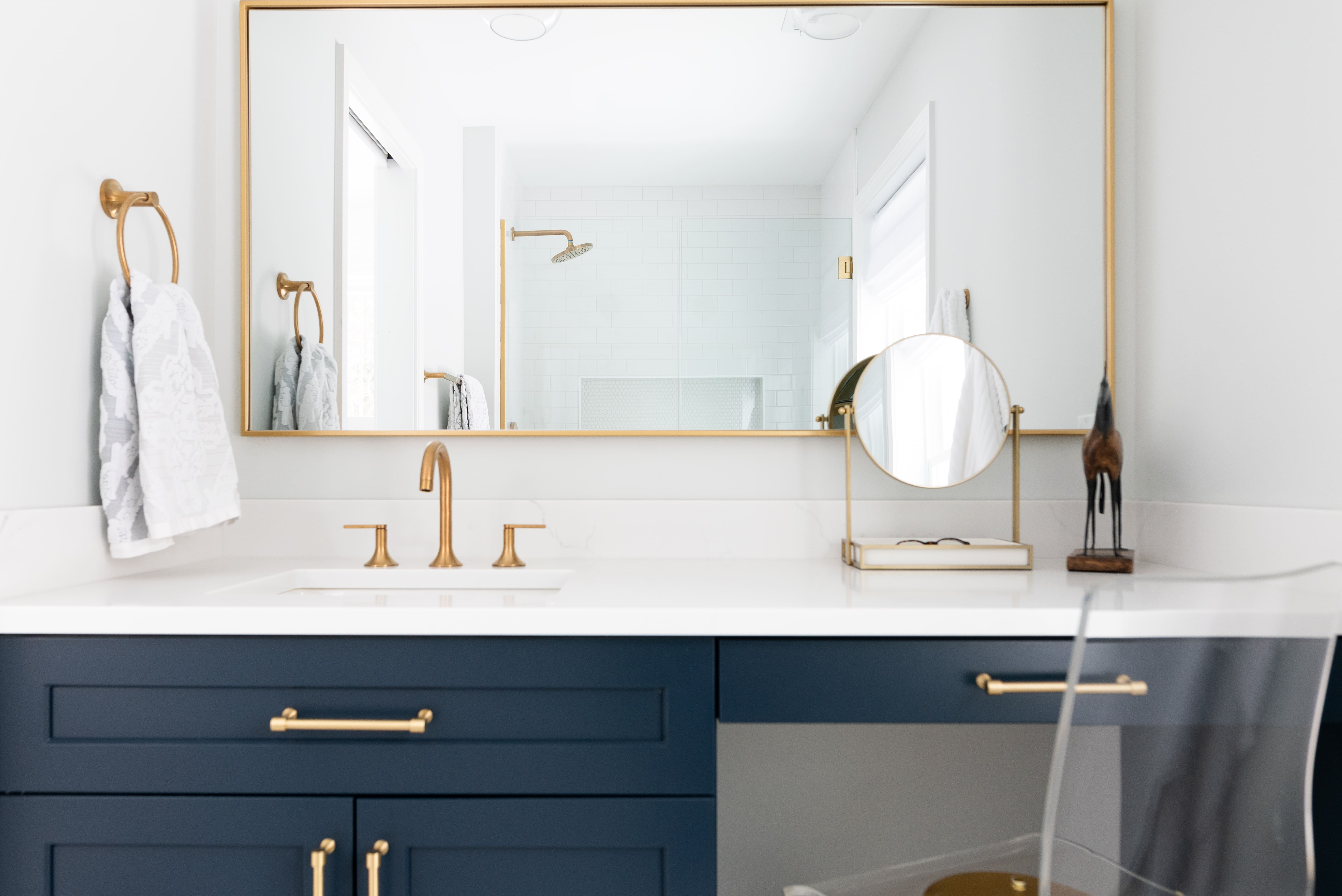 Blue vanity setup with makeup area in remodeled bathroom cleveland