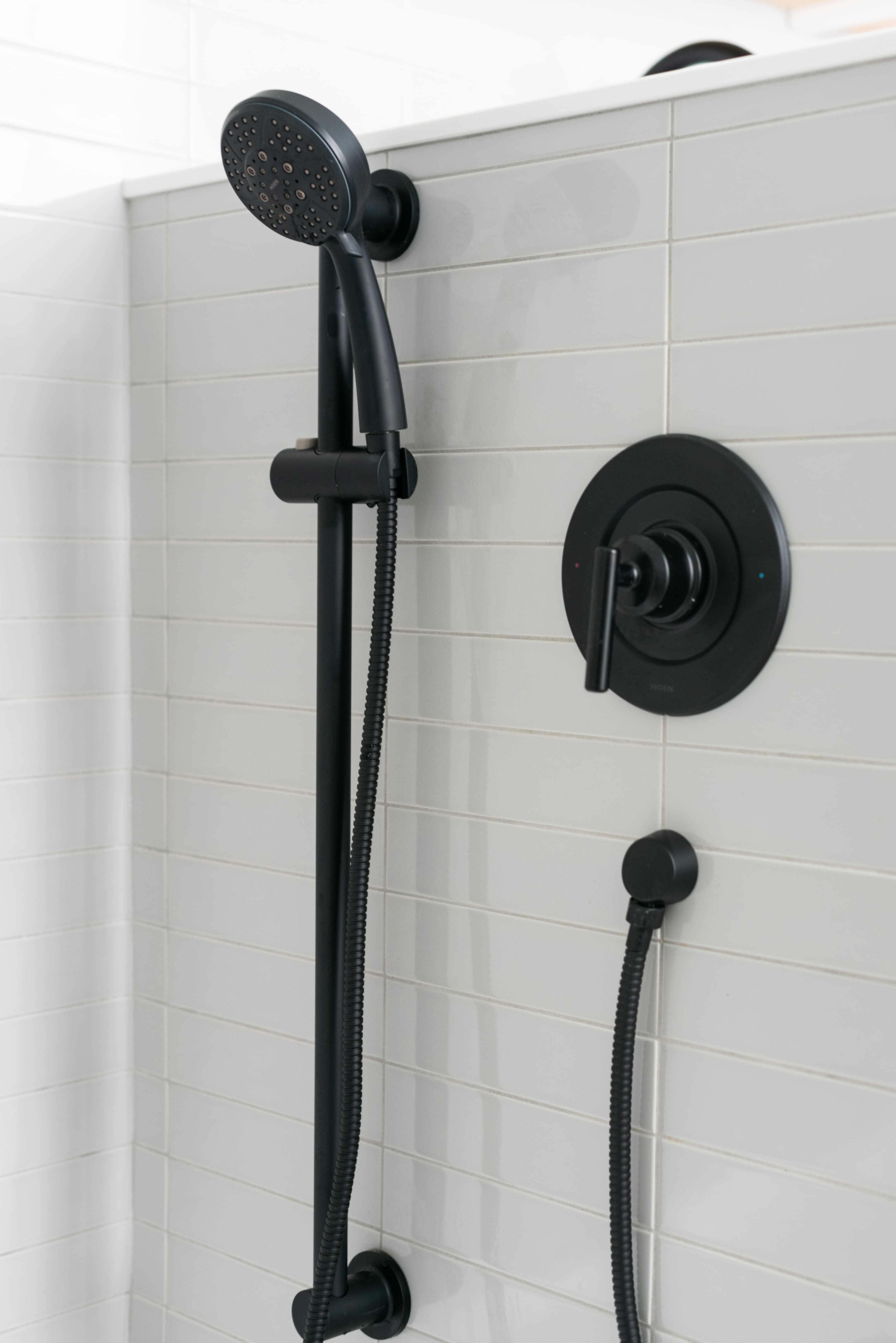 black shower head subway tile shower