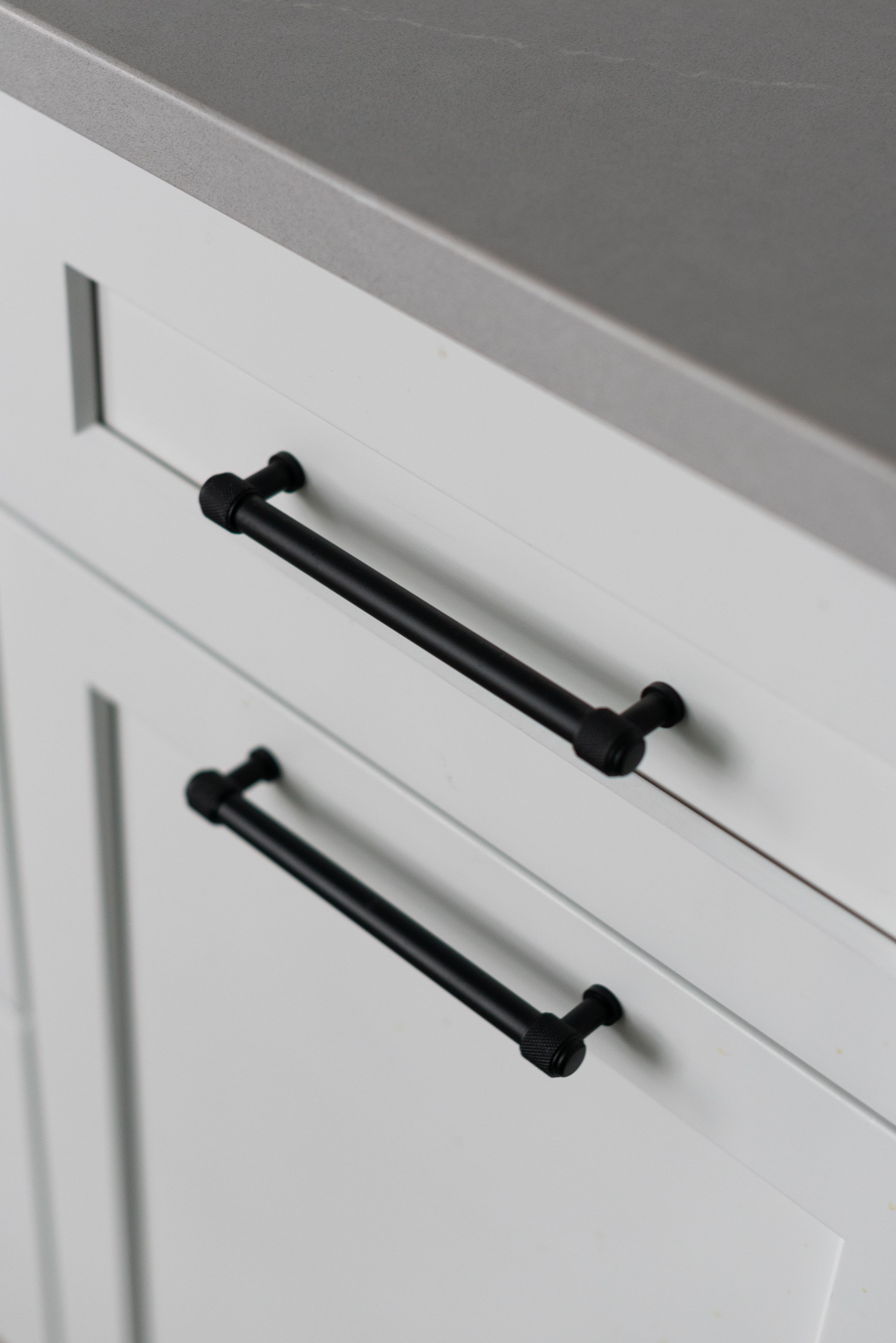 black hardware on white cabinet in mudroom remodel