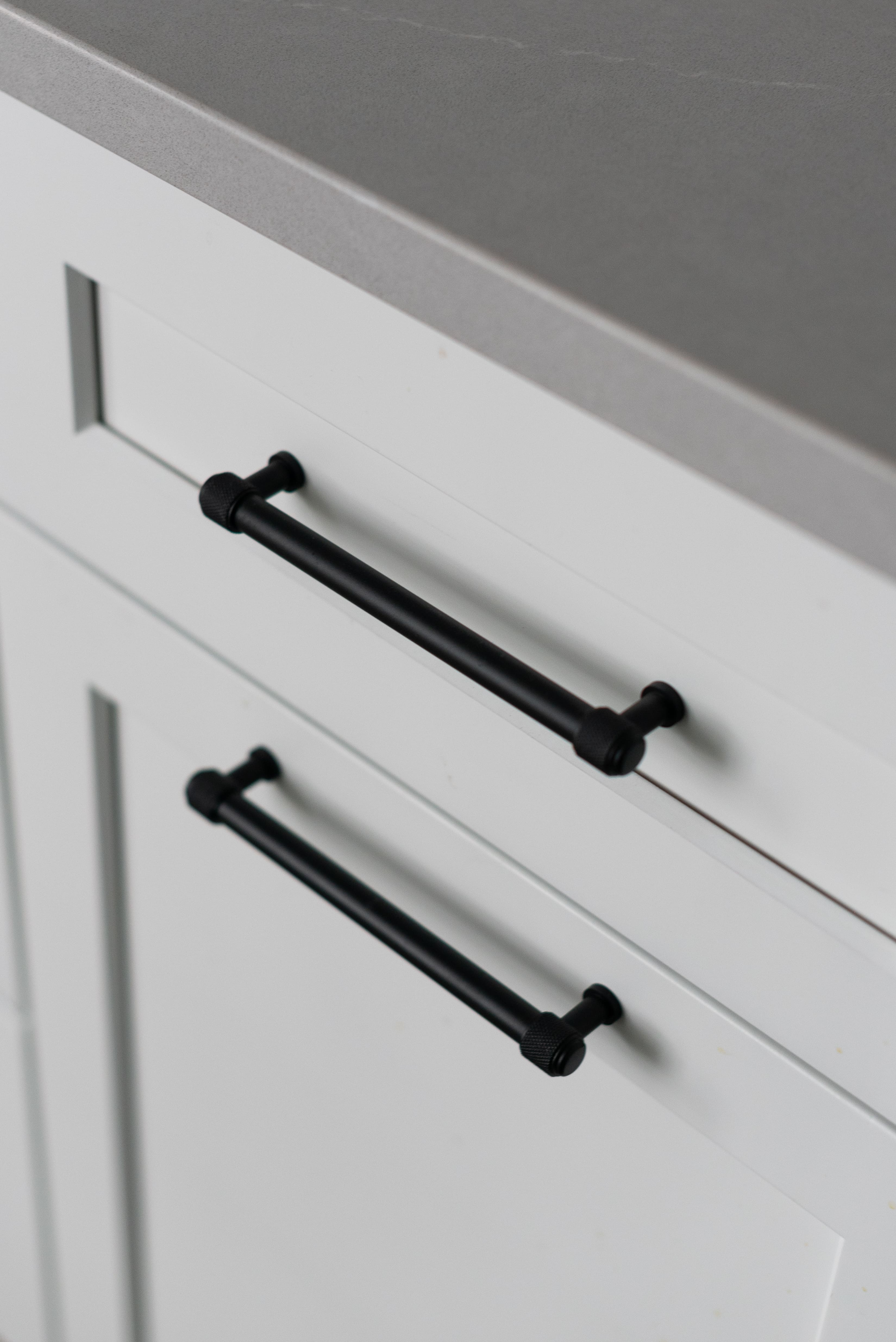 black hardware on white cabinet